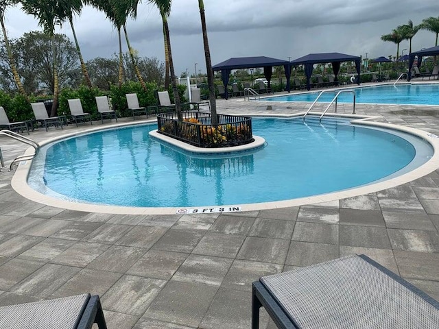 view of swimming pool with a gazebo and a patio