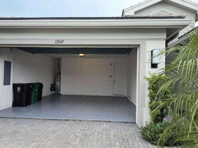 garage featuring electric panel and gas water heater