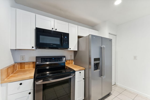 kitchen featuring white cabinetry, appliances with stainless steel finishes, butcher block counters, and light tile patterned floors