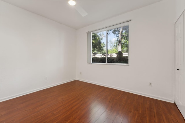 spare room featuring dark hardwood / wood-style floors and ceiling fan