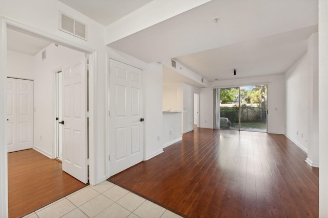 empty room with light hardwood / wood-style flooring