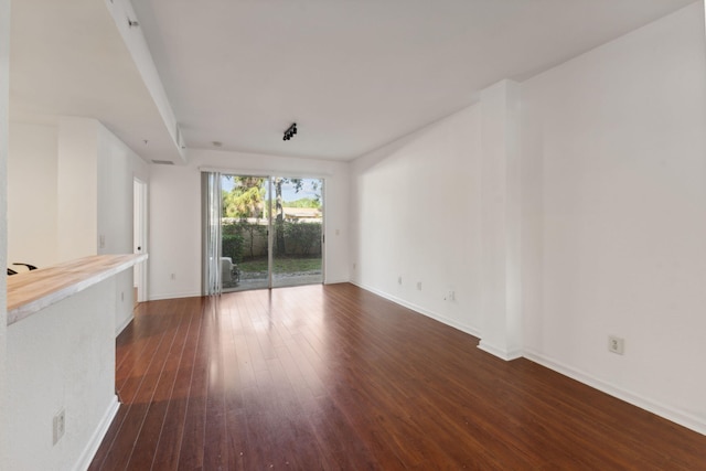 empty room with dark wood-type flooring