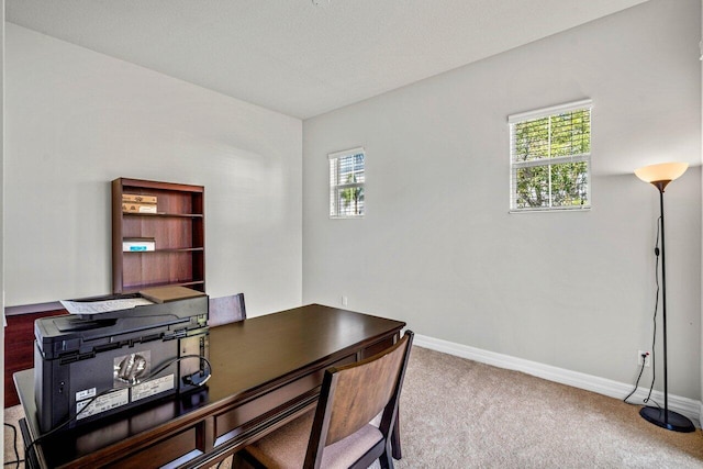 carpeted home office featuring a wealth of natural light and baseboards