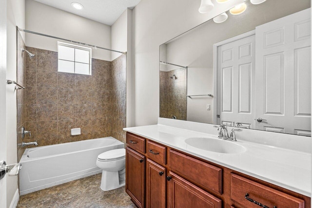 full bathroom featuring toilet, tiled shower / bath, and vanity