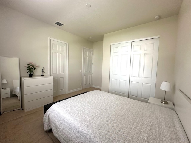 bedroom featuring carpet floors, visible vents, and a closet