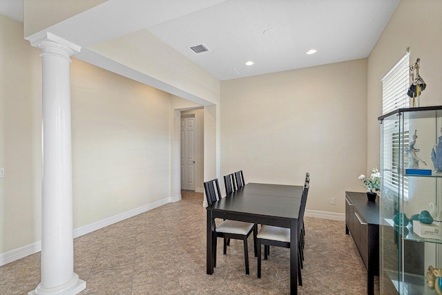 dining space featuring decorative columns