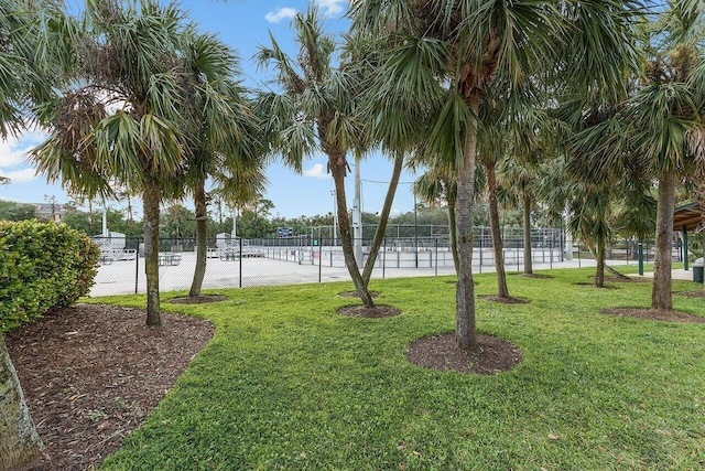 view of community featuring a yard and fence