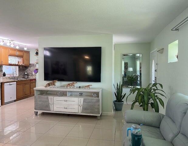 tiled living room with a textured ceiling and sink