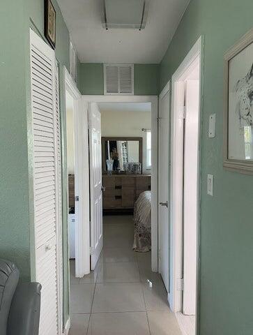 corridor featuring light tile patterned floors