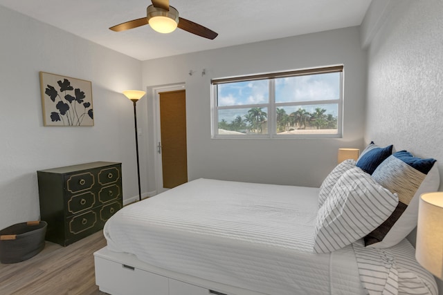 bedroom featuring light hardwood / wood-style flooring and ceiling fan