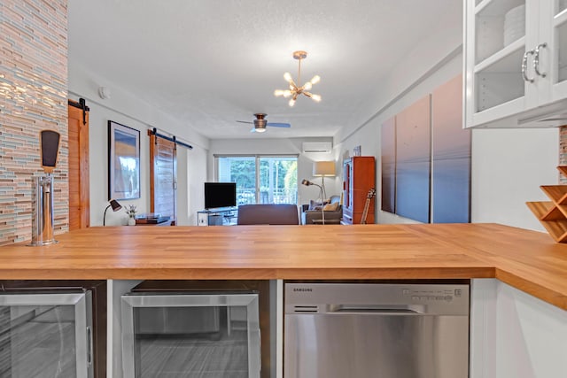 kitchen featuring wine cooler, wooden counters, stainless steel dishwasher, and a barn door