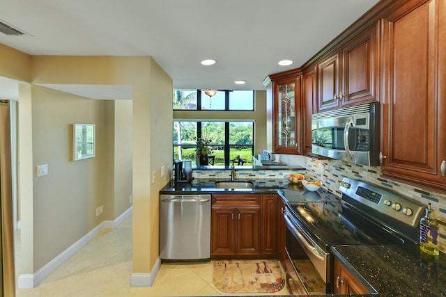 living room with a high ceiling, light tile patterned floors, and ceiling fan