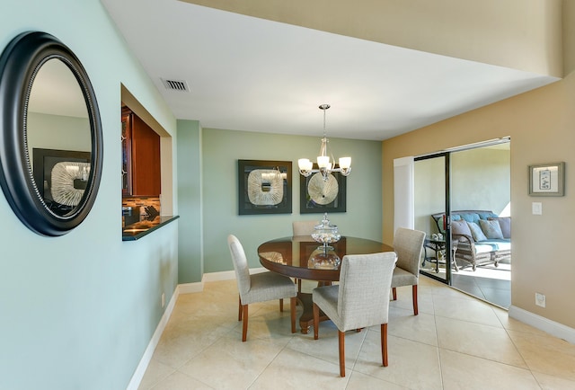 tiled dining space featuring a chandelier