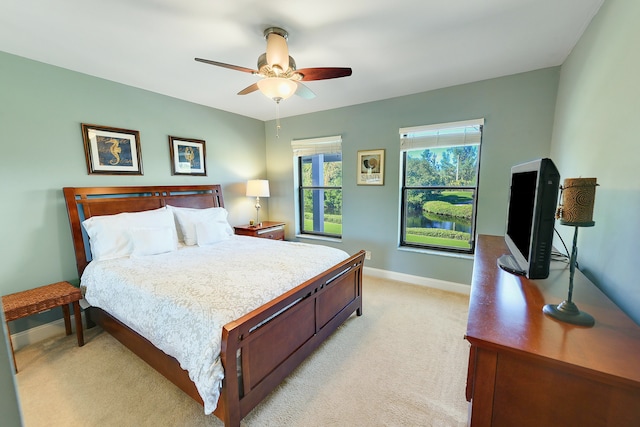 bedroom featuring ceiling fan and light colored carpet