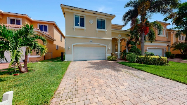 mediterranean / spanish-style home featuring a garage and a front lawn