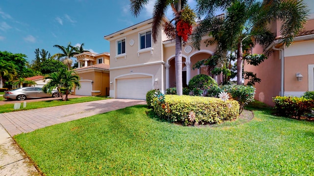 mediterranean / spanish house with a garage and a front lawn