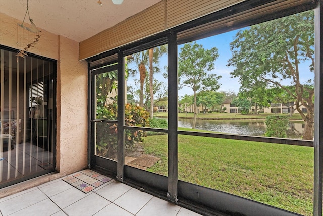 unfurnished sunroom with a water view