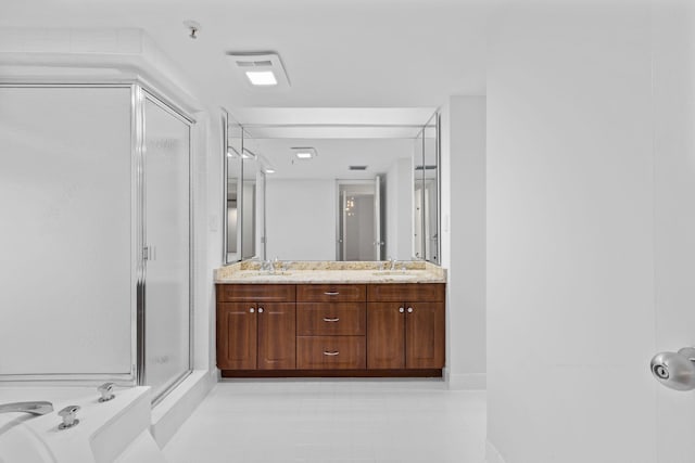 bathroom featuring tile patterned flooring, vanity, and a shower with door