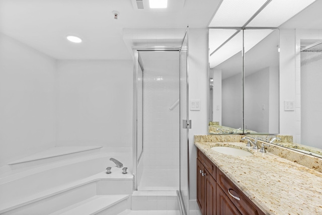 bathroom featuring vanity and independent shower and bath