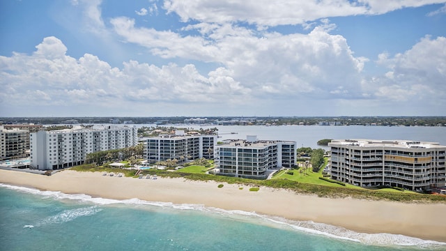 drone / aerial view featuring a water view and a view of the beach