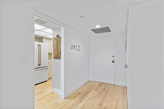 corridor with light hardwood / wood-style floors