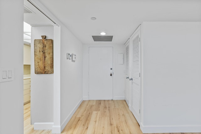 hallway with light hardwood / wood-style flooring