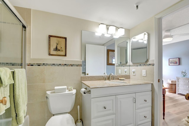 bathroom featuring vanity, tile walls, and hardwood / wood-style flooring