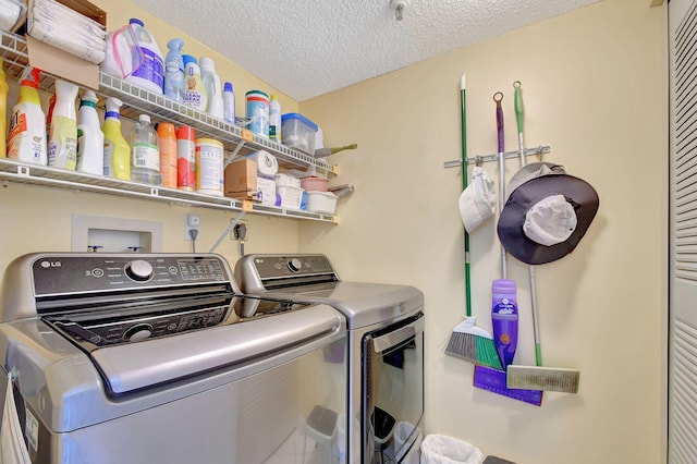 washroom featuring independent washer and dryer and a textured ceiling