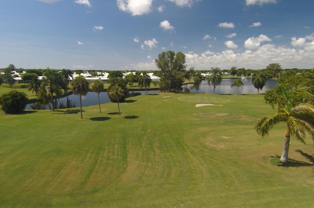 view of home's community featuring a water view and a lawn