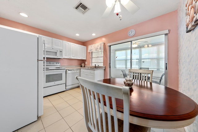 kitchen featuring white cabinets, white appliances, sink, and light tile patterned floors