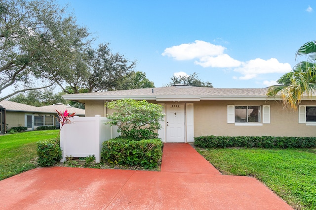 ranch-style house with a front lawn