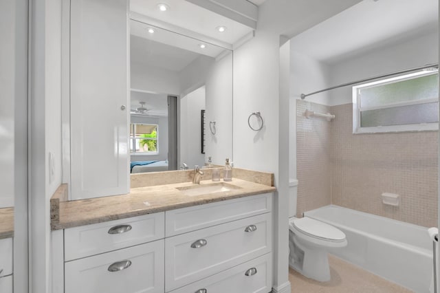 full bathroom with vanity, toilet, and tiled shower / bath combo