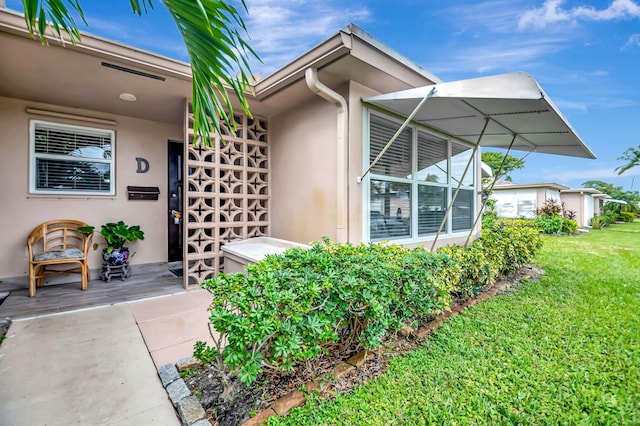 entrance to property with a yard