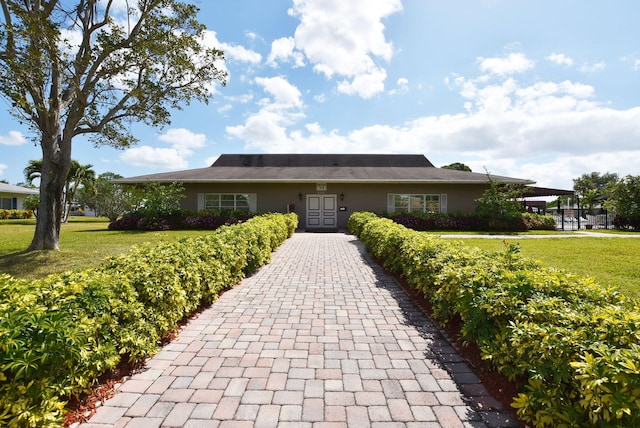 ranch-style home with a front yard