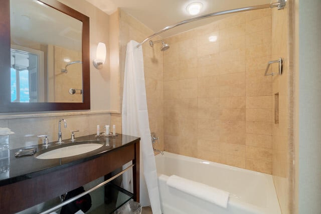 bathroom with vanity and shower / bath combination with curtain