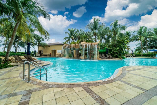 view of pool featuring pool water feature and a patio