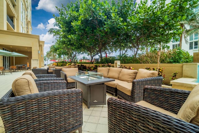 view of patio with an outdoor living space with a fire pit