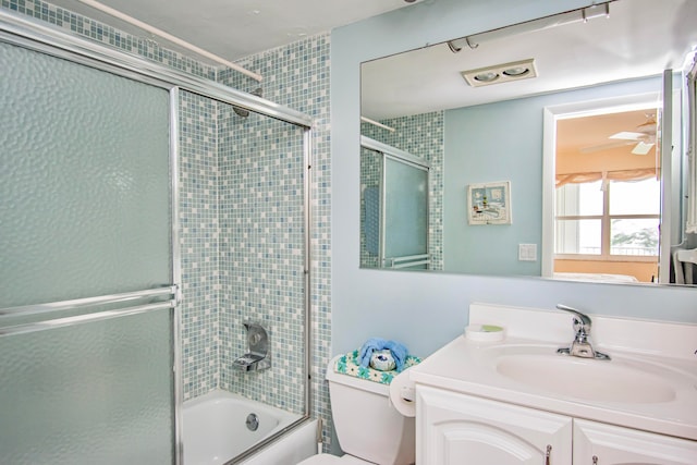 full bathroom with vanity, toilet, and bath / shower combo with glass door