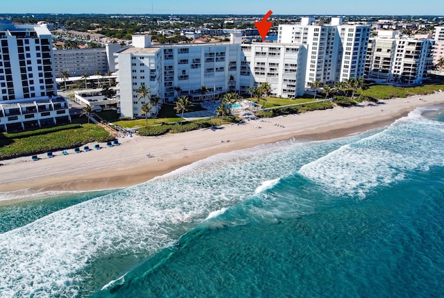 bird's eye view featuring a water view and a beach view