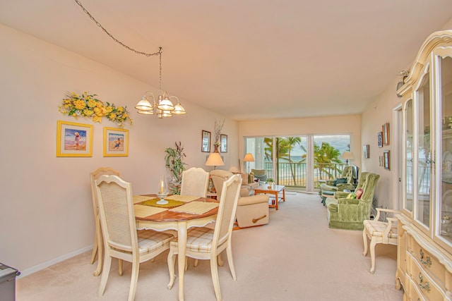 dining area featuring light carpet and a notable chandelier