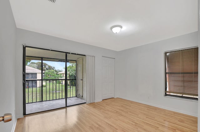 unfurnished room with light wood-type flooring