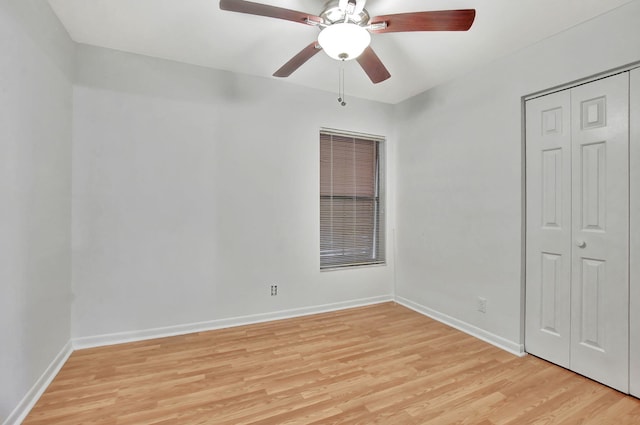 unfurnished bedroom with ceiling fan, a closet, and light wood-type flooring