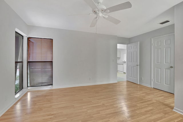 unfurnished room with ceiling fan and light wood-type flooring