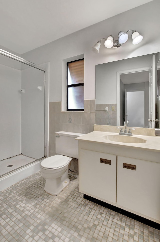 bathroom with vanity, tile patterned flooring, walk in shower, and tile walls