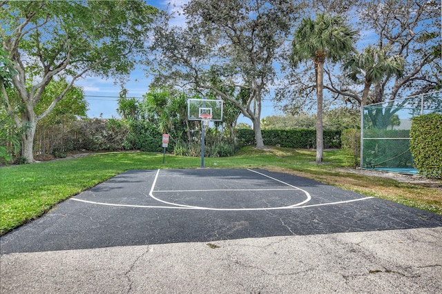 view of sport court featuring a yard