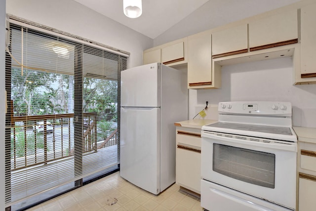 kitchen with lofted ceiling, plenty of natural light, white electric stove, and fridge