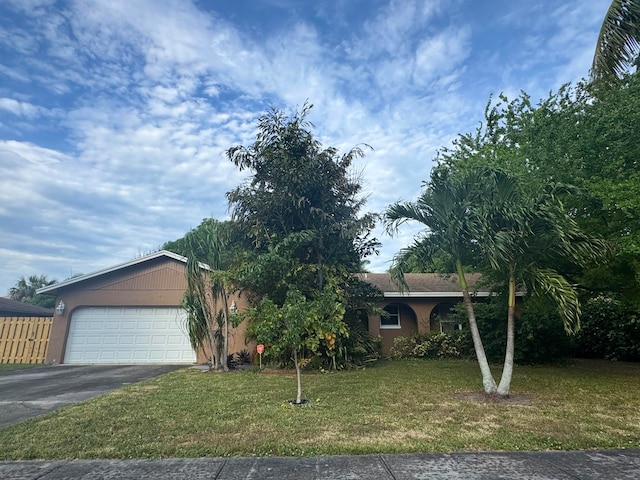 view of front facade with a garage and a front lawn