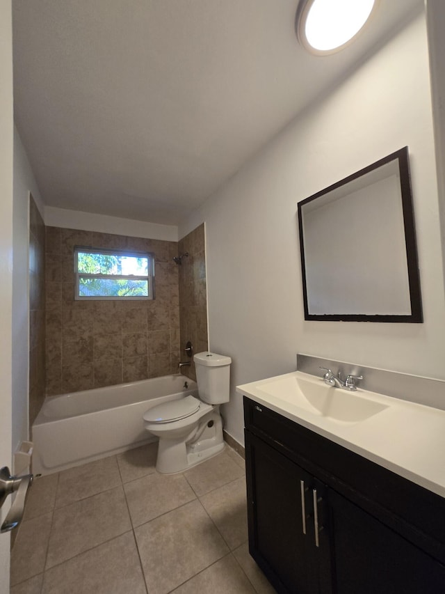 full bathroom with tile patterned flooring, vanity, toilet, and tiled shower / bath