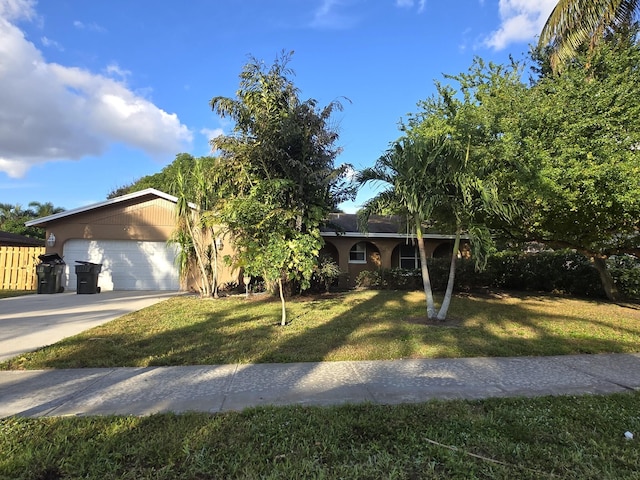 ranch-style home with a front yard and a garage