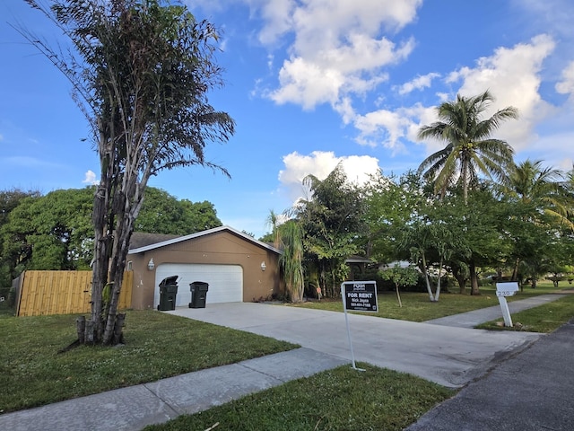 view of front of property featuring a garage and a front lawn